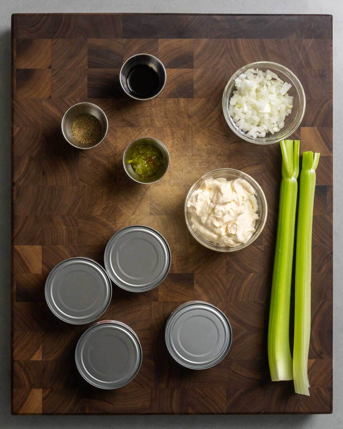 Ingredients shown: celery salt, soy sauce, relish, mayonnaise, onion, celery, and canned tuna.