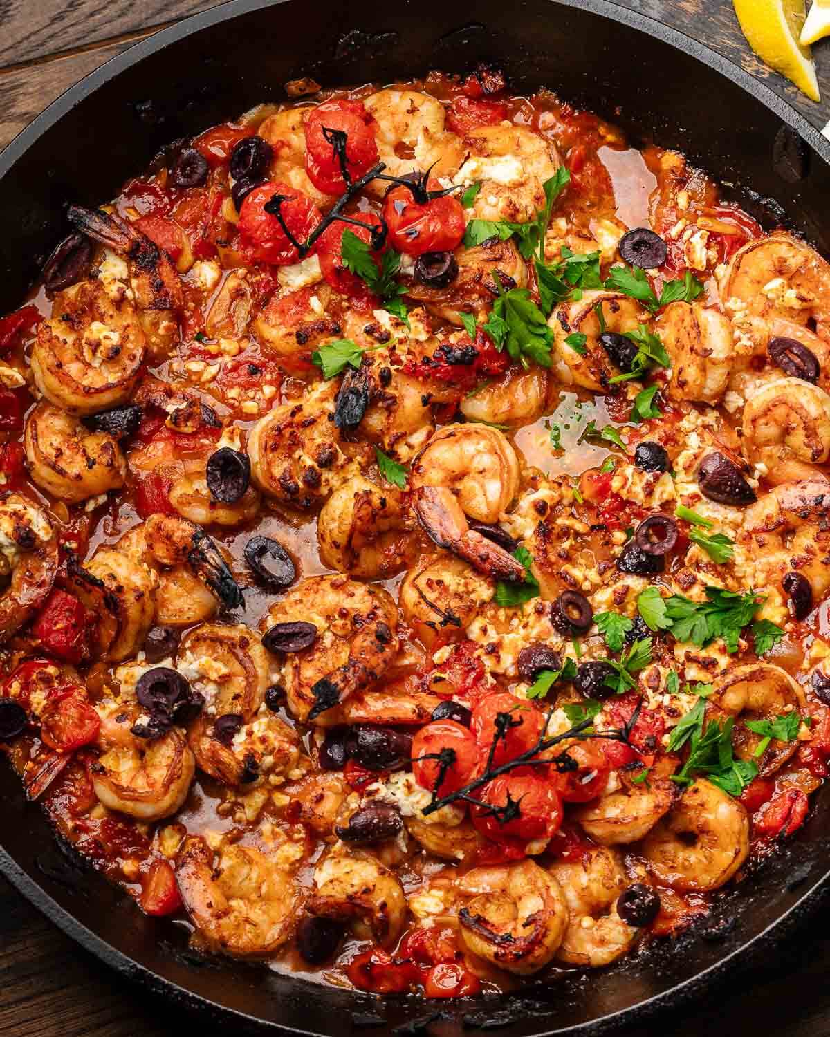 Shrimp saganaki in cast iron pan.