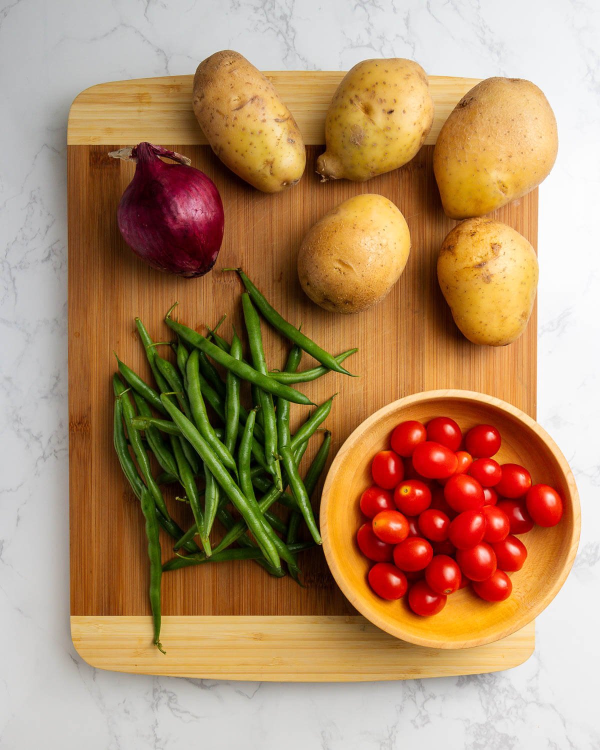 Ingredients shown: red onion, potatoes, green beans, cherry tomatoes.
