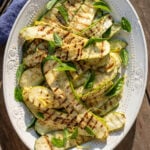 Grilled zucchini in white platter.