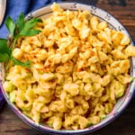 Spaetzle in small bowl with parsley garnish.