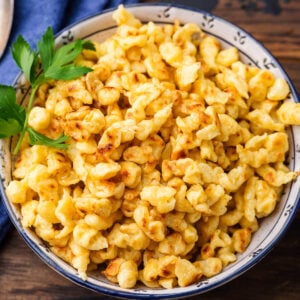 Spaetzle in small bowl with parsley garnish.