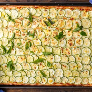 Overhead shot of zucchini pizza in pizza pan.