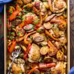 Chicken Scarpariello in gold baking pan with serving fork.