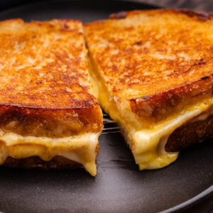 Closeup shot of sliced sourdough grilled cheese.