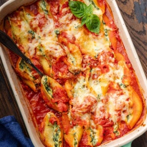Baking dish filled with spinach ricotta stuffed shells.