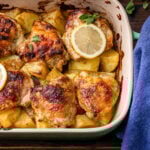 Greek lemon chicken and potatoes in baking dish.