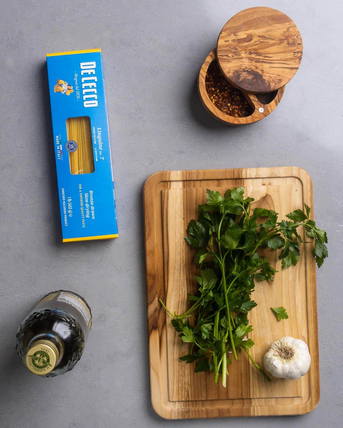 Recipe ingredients shown: box of linguine, hot red pepper flakes, extra virgin olive oil, flat-leaf Italian parsley, and garlic.