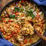 Mediterranean chicken and orzo in large black pan.