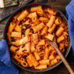 Pasta alla Zozzona in large black pan with blue napkins.