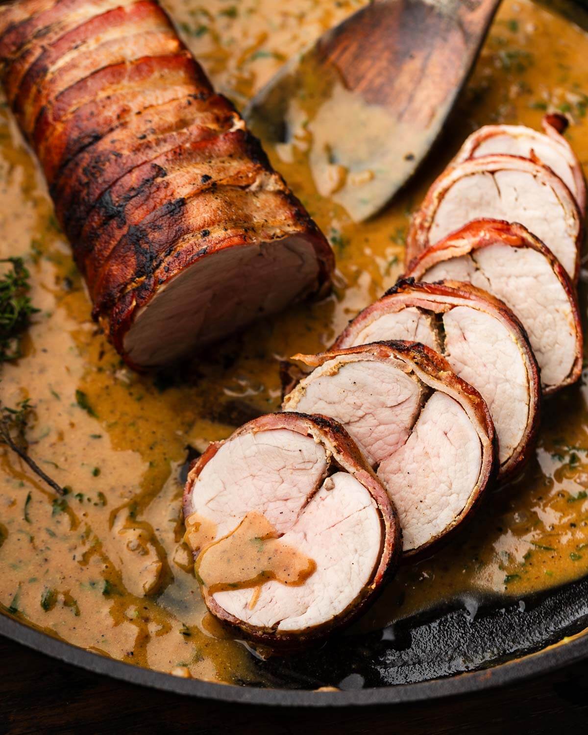 Sliced pork tenderloin with pan sauce.