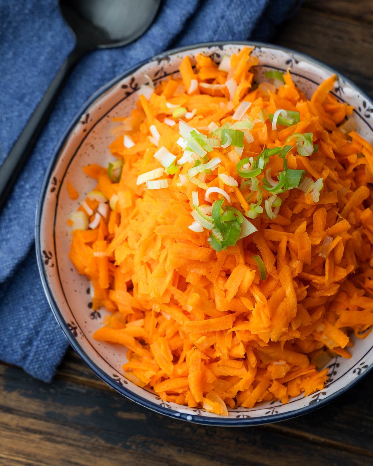 Carrot salad in white bowl.