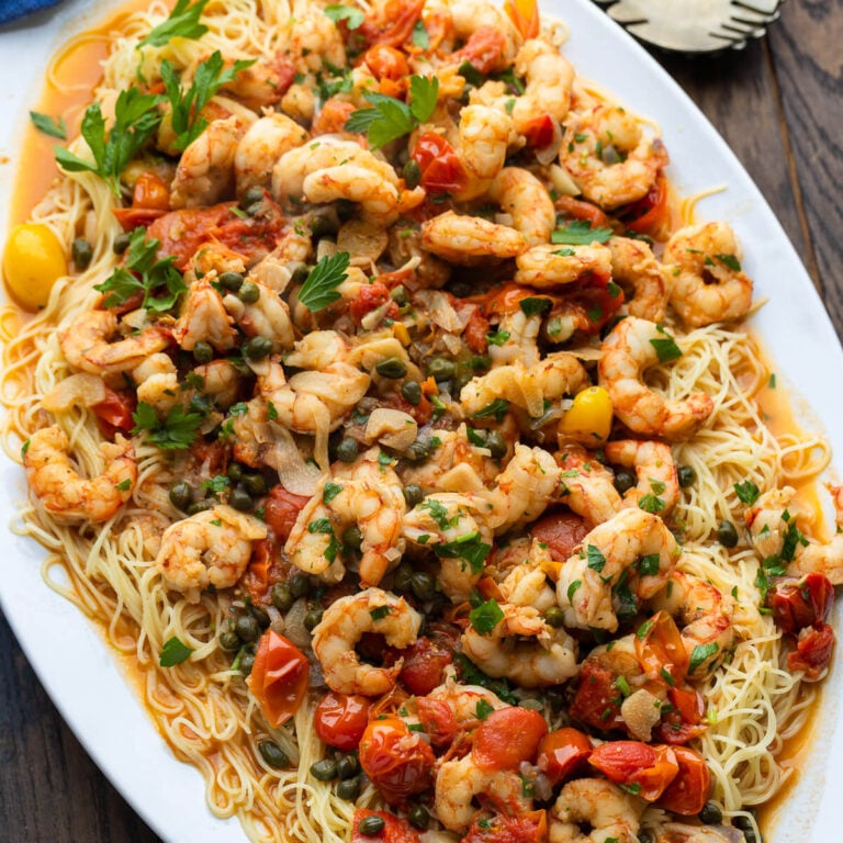 Old Bay shrimp with capellini in white platter.