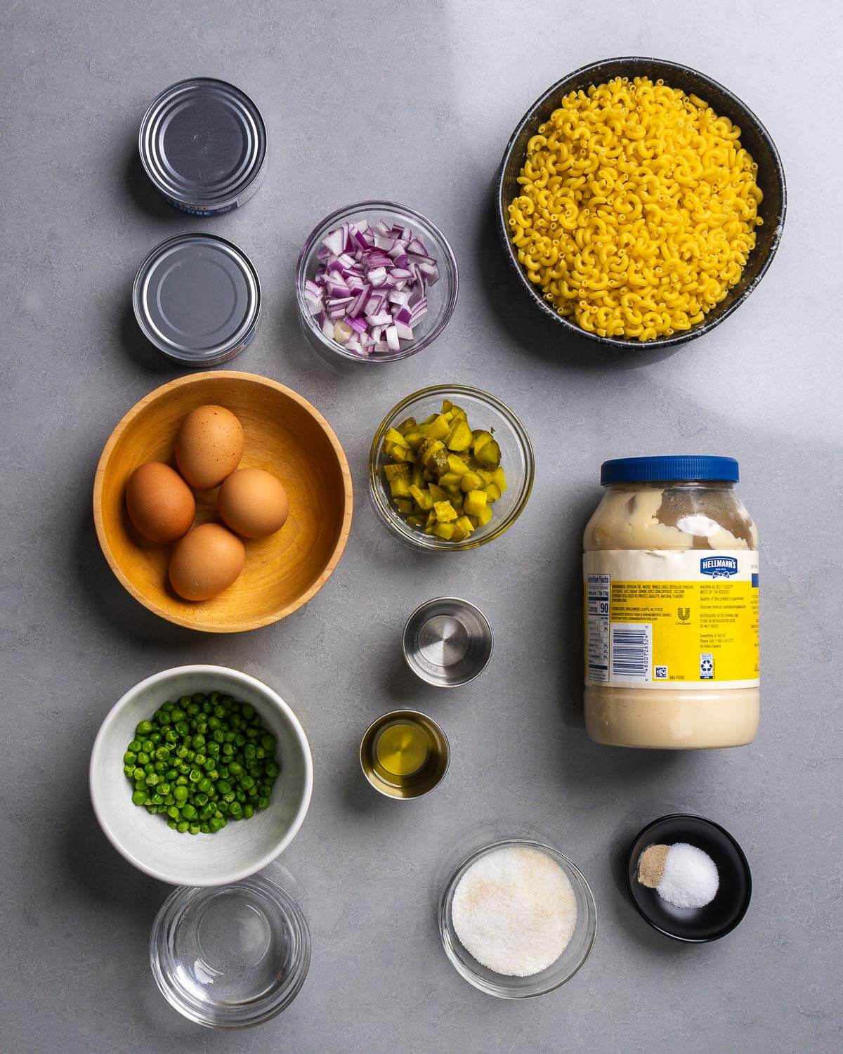 Ingredient shown: canned tuna, red onion, elbow macaroni, eggs, dill pickles, peas, oil, vinegar, mayonnaise, water, sugar, salt, and pepper.