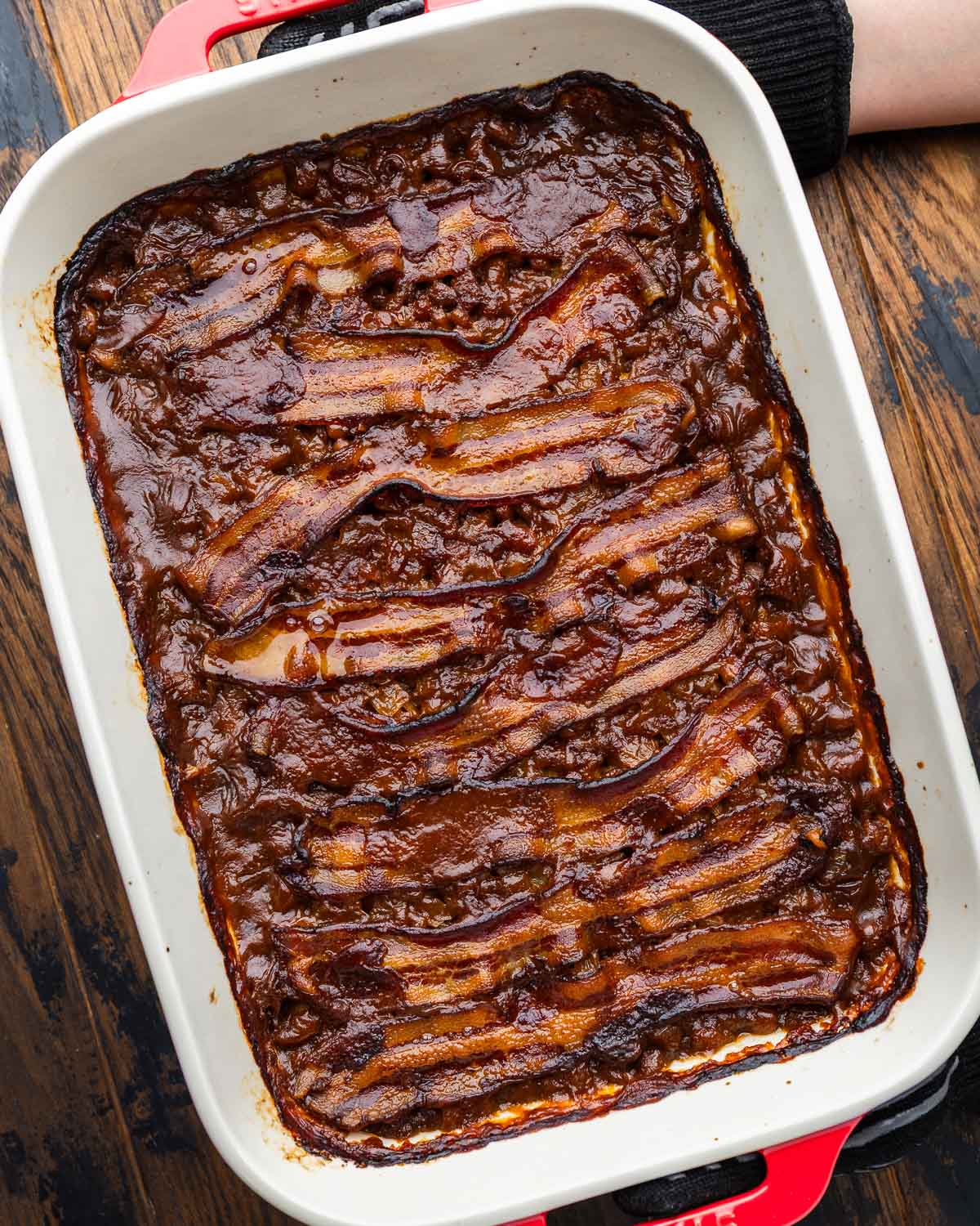Hands holding baked beans.