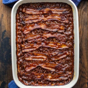 Baked beans in large baking dish.
