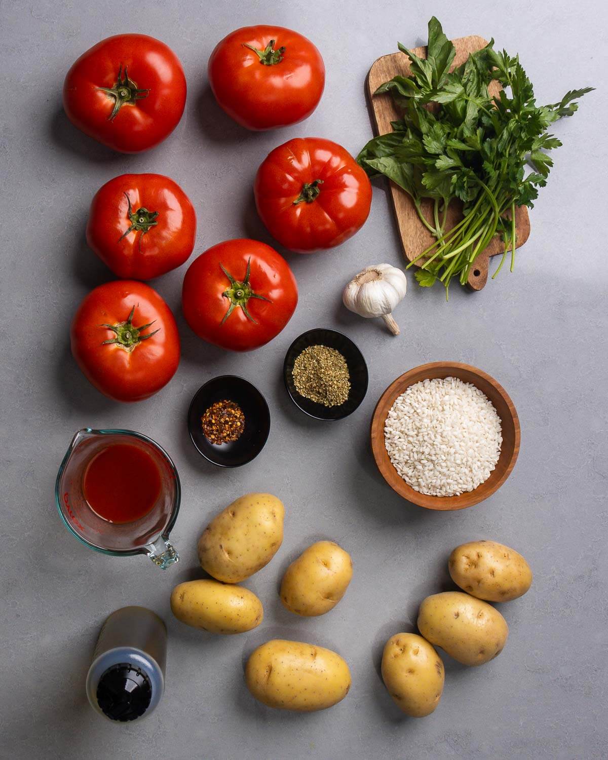 Ingredients shown: large tomatoes, basil and parsley, passata, hot red pepper flakes, oregano, garlic, rice, olive oil, and potatoes.