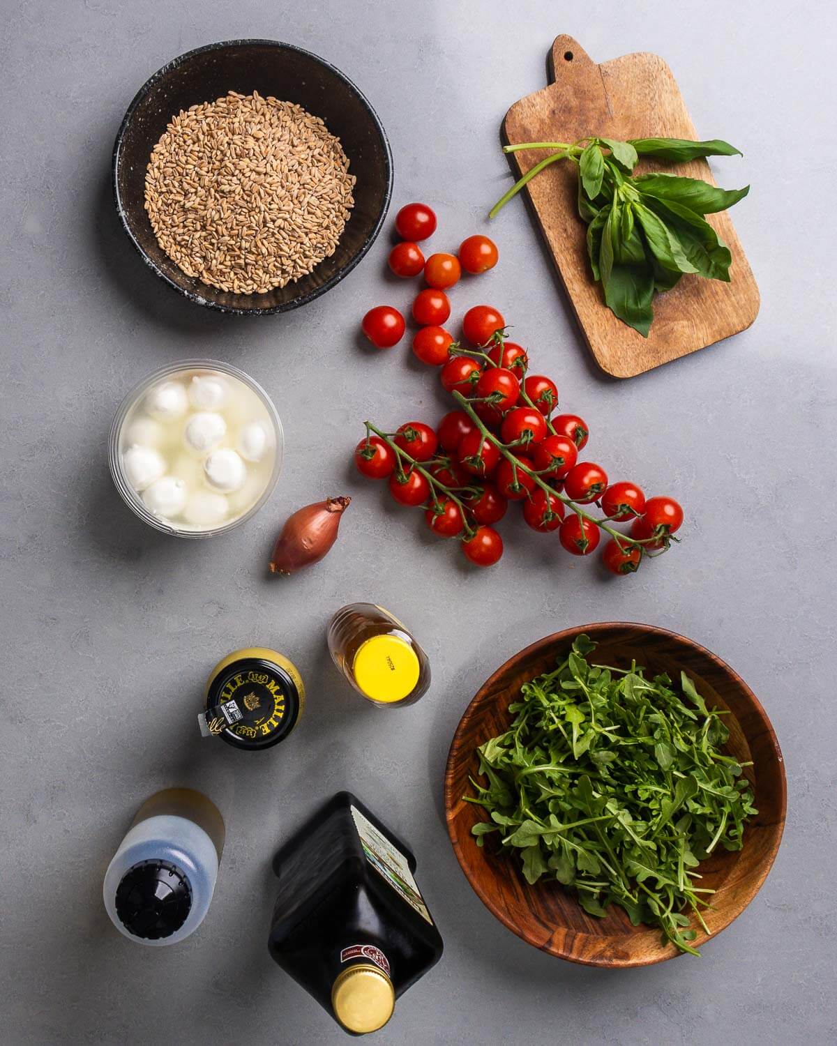 Ingredients shown: farro, basil, cherry tomatoes, mozzarella balls, shallot, honey, Dijon mustard, olive oil, balsamic vinegar, and arugula.
