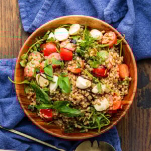 Caprese farro salad in wood bowl.