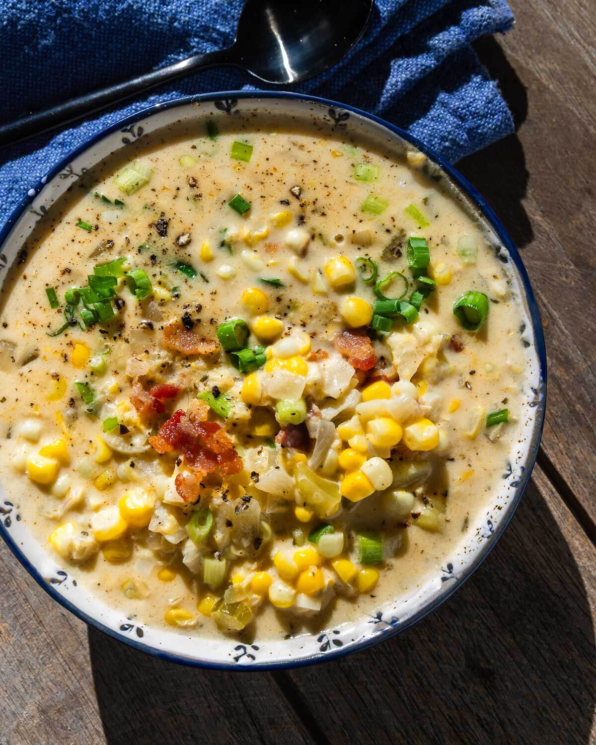 Corn chowder in bowl with sunlight.