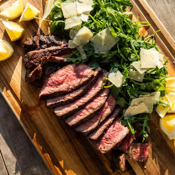 Steak Tagliata on wooden cutting board.
