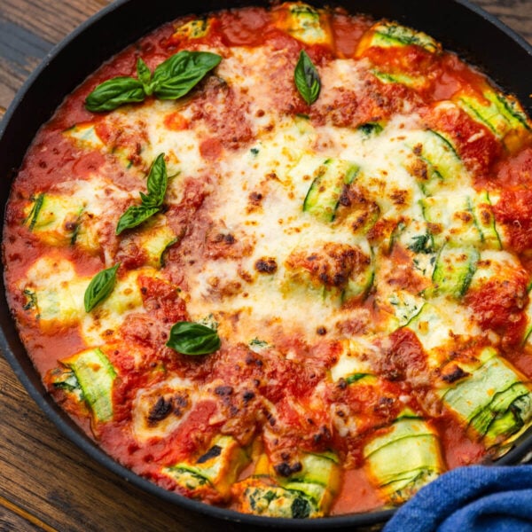 Zucchini rollatini in large black pan.