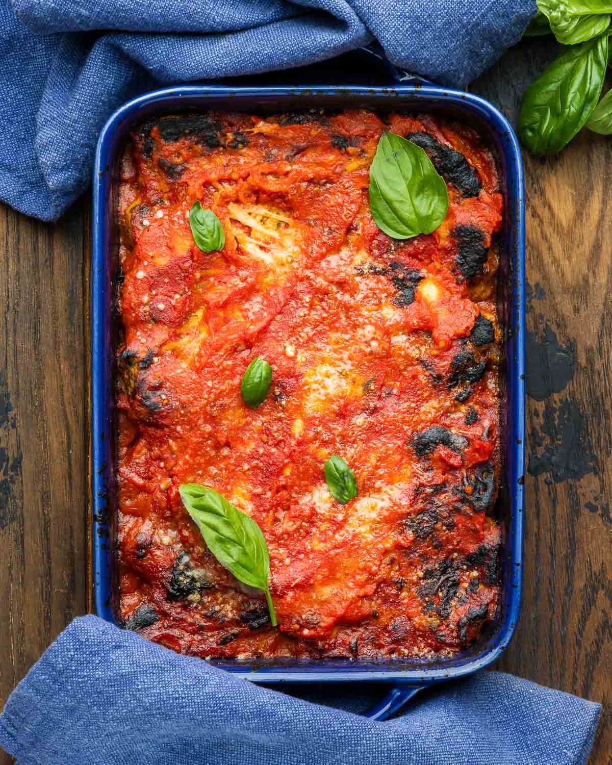 Blue baking dish with artichoke parmesan.