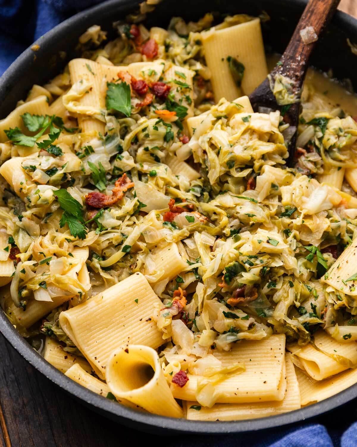 Cabbage bacon pasta in pan.