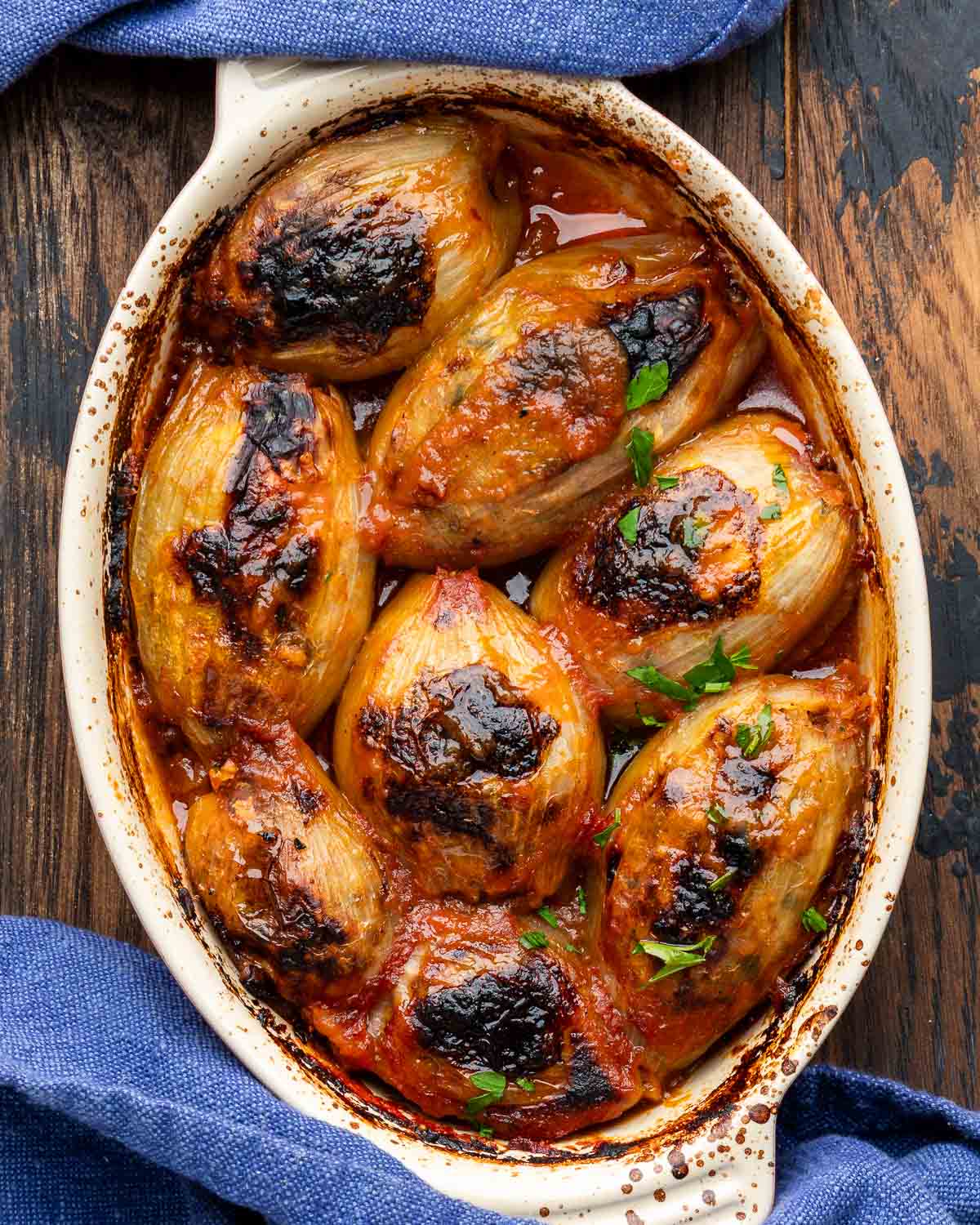 Greek stuffed onions in baking dish on table.