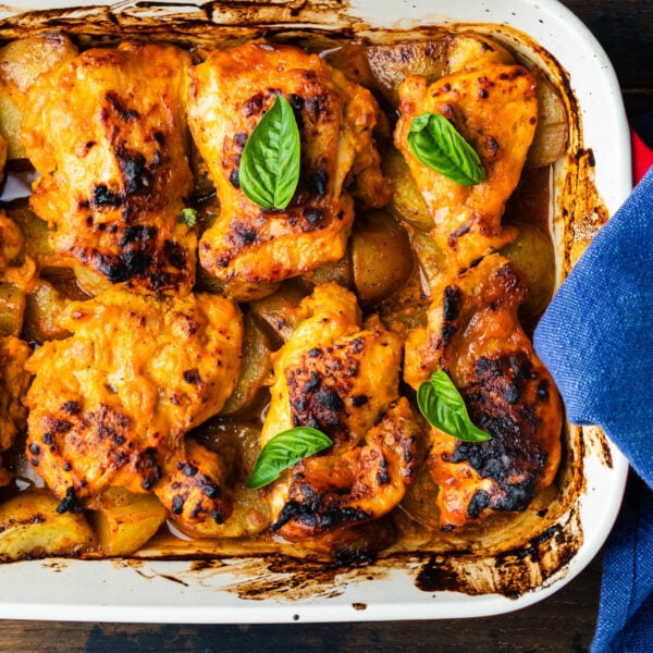 One-pan hot honey chicken and potatoes in baking dish.