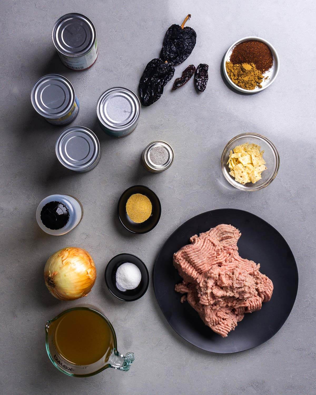 Ingredients shown: beans, chiles, spices, tomato paste, olive oil, garlic powder, tortillas, onion, salt, ground turkey, and chicken stock.