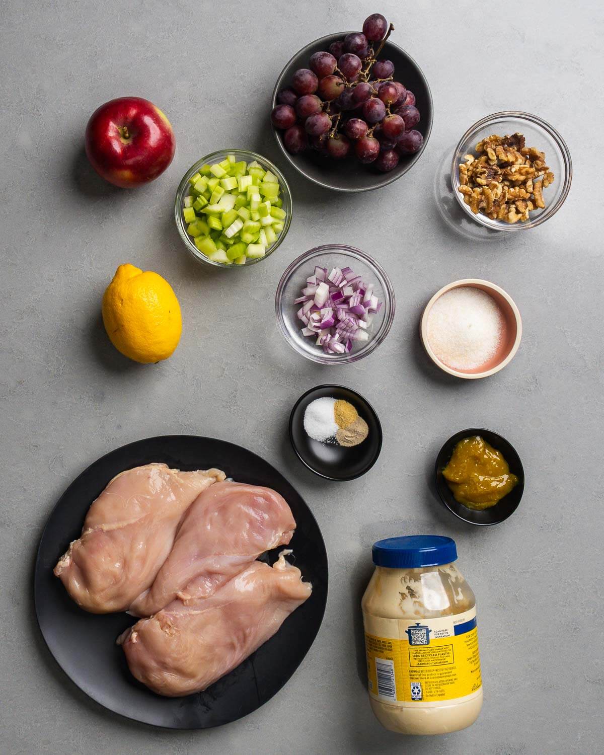 Ingredients shown: apple, celery, grapes, walnuts, lemon, red onon, sugar, spices, chicken base, chicken breasts, and mayonnaise.
