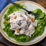 Waldorf chicken salad on top of a bed of lettuce.