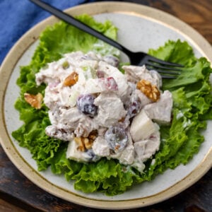 Waldorf chicken salad on top of a bed of lettuce.