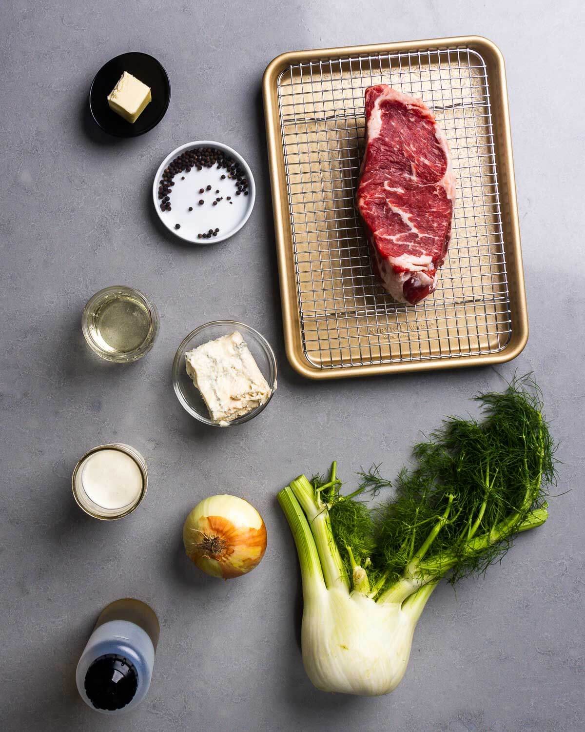 Ingredients shown: butter, peppercorns, New York strip steak, wine, gorgonzola, cream, onion, olive oil, and fennel bulb.