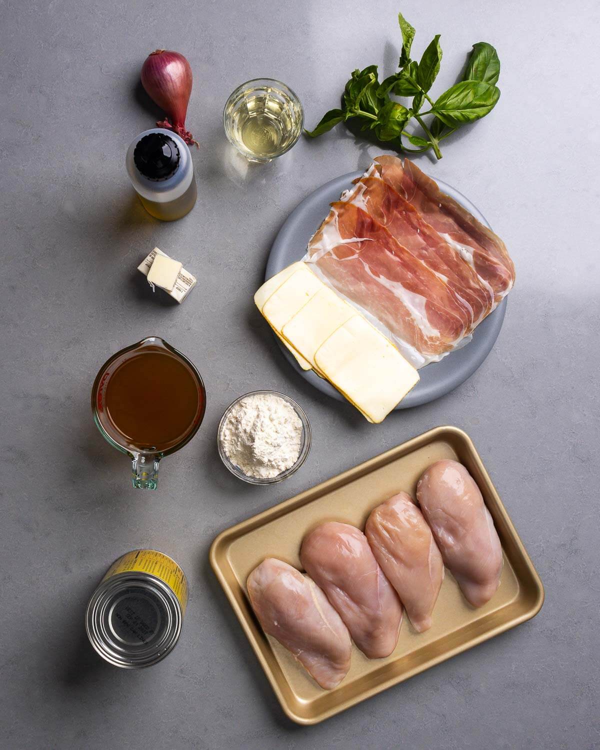 Ingredients shown: shallot, olive oil, white wine, basil, American muenster cheese, prosciutto, chicken stock, flour, canned tomatoes, and chicken breasts.
