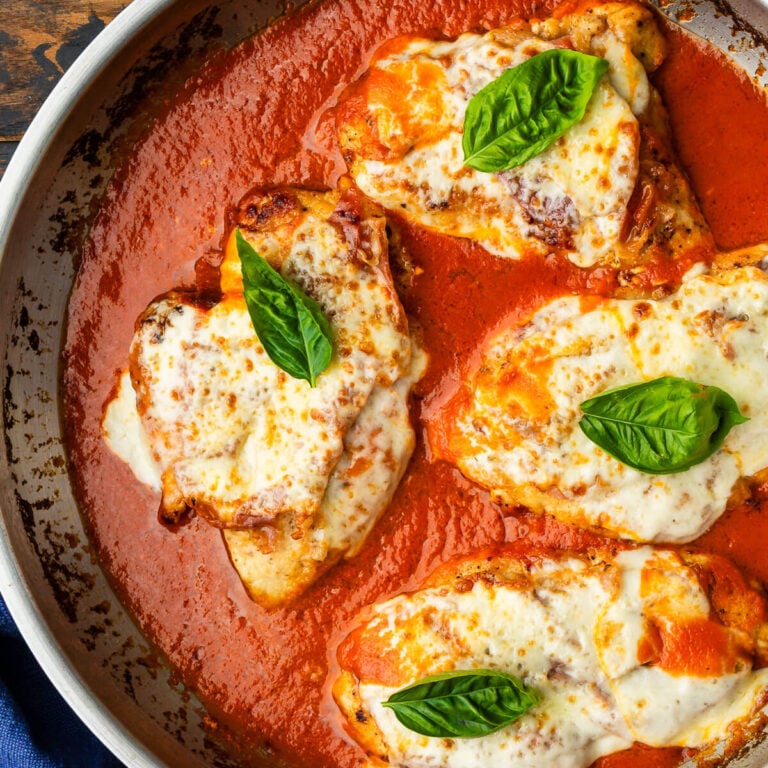 Pan of chicken with prosciutto and cheese in creamy tomato sauce.