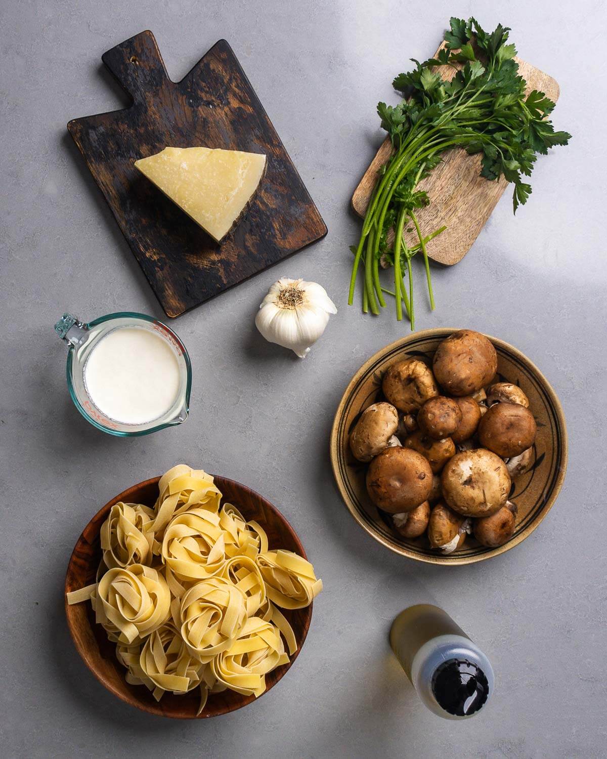 Ingrediens shown: Pecorino Romano, garlic, parsley, cream, mushrooms, pappardelle pasta, and olive oil.