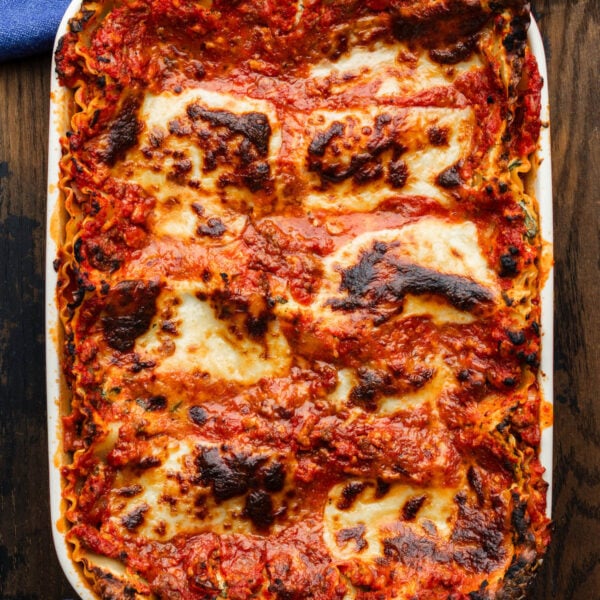 Lasagna in white baking dish.