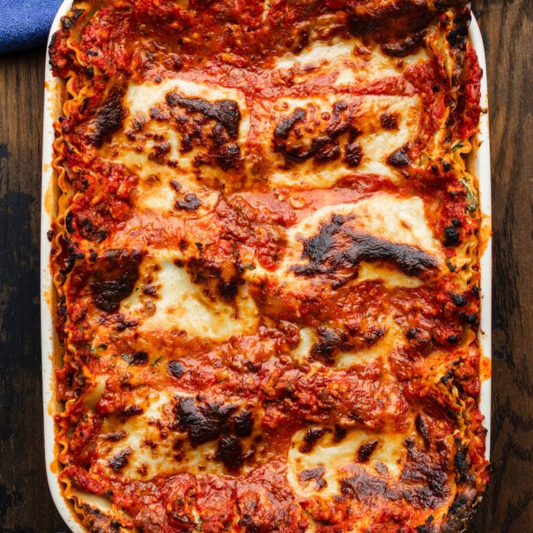 Lasagna in white baking dish.