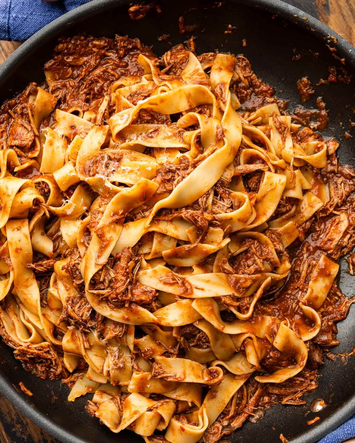 Large pan with pappardelle and Sicilian pork ragu.