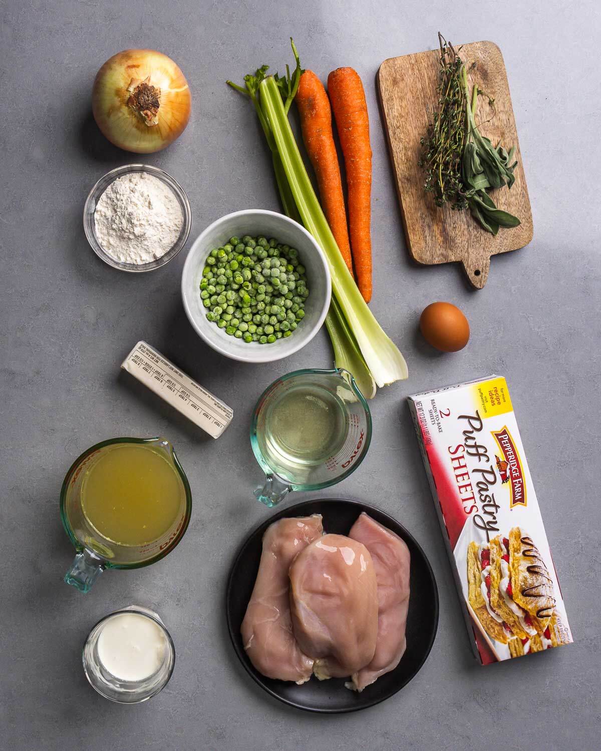 Ingredients shown: onion, flour, celery, carrots, thyme, sage, peas, butter, wine, egg, chicken stock, puff pastry, cream, and chicken breasts.