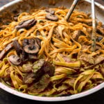 Creamy bourbon steak and mushroom pasta in large pan.