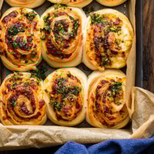 Closeup shot of grey pan with cheesy garlic rolls.
