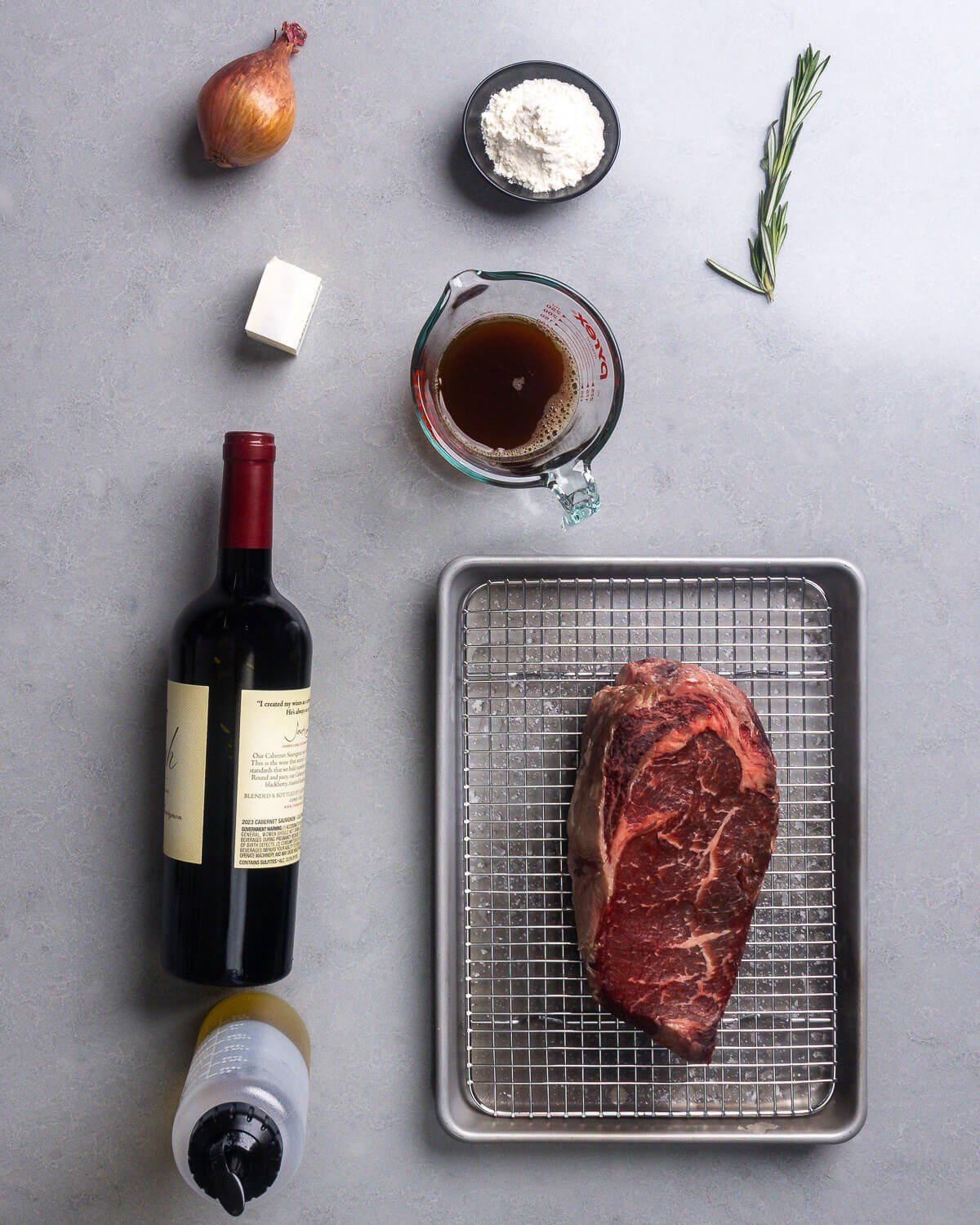 Ingredients shown: shallot, butter, flour, beef stock, rosemary, red wine, olive oil, and salted ribeye steak.
