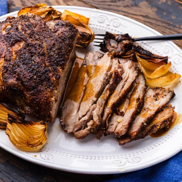 Large platter with sliced Italian roasted pork shoulder.
