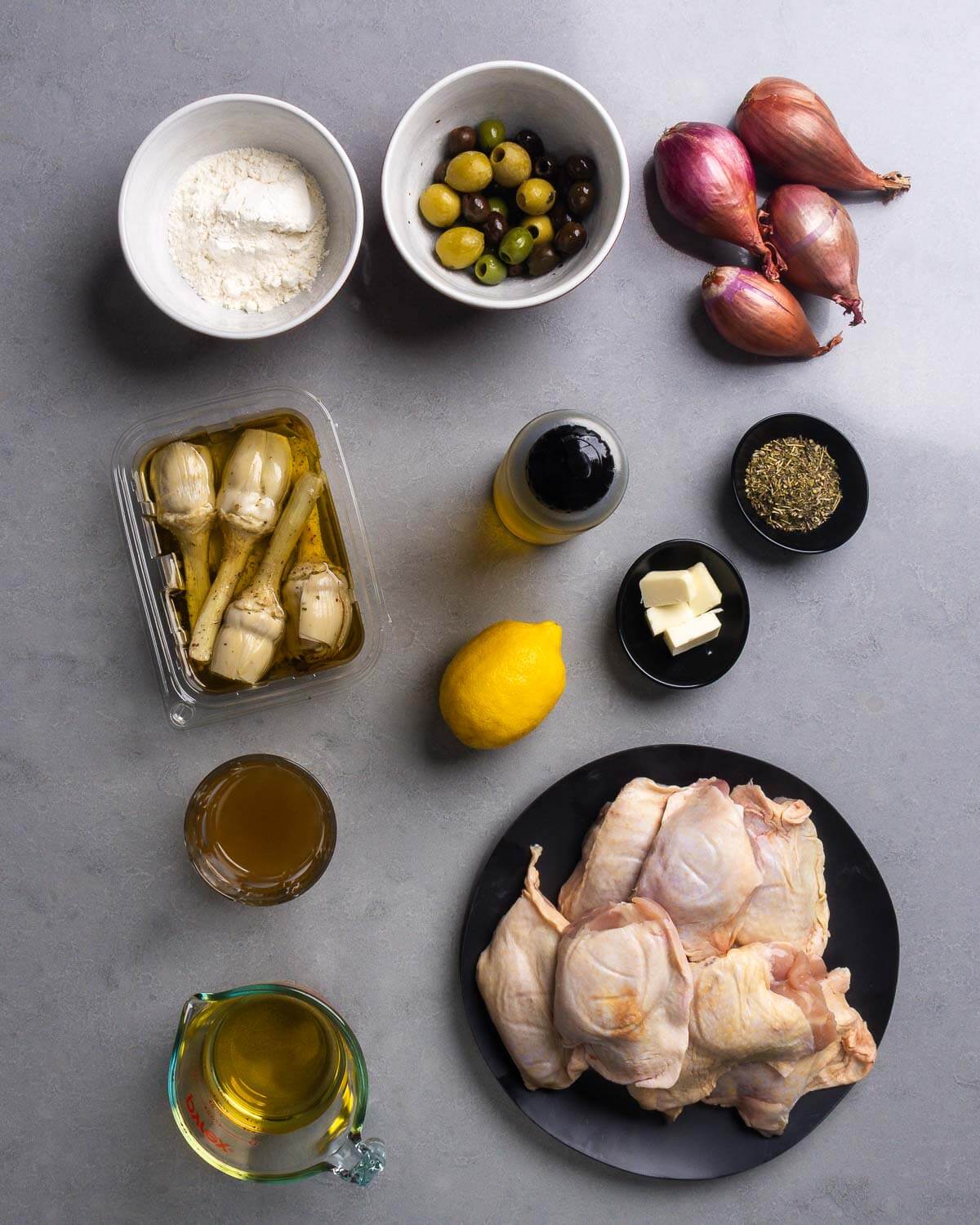 Ingredients shown: flour, olives, shallots, marinated artichoke hearts, olive oil, butter, lemon, herbes de provence, chicken stock, white wine, and chicken thighs.