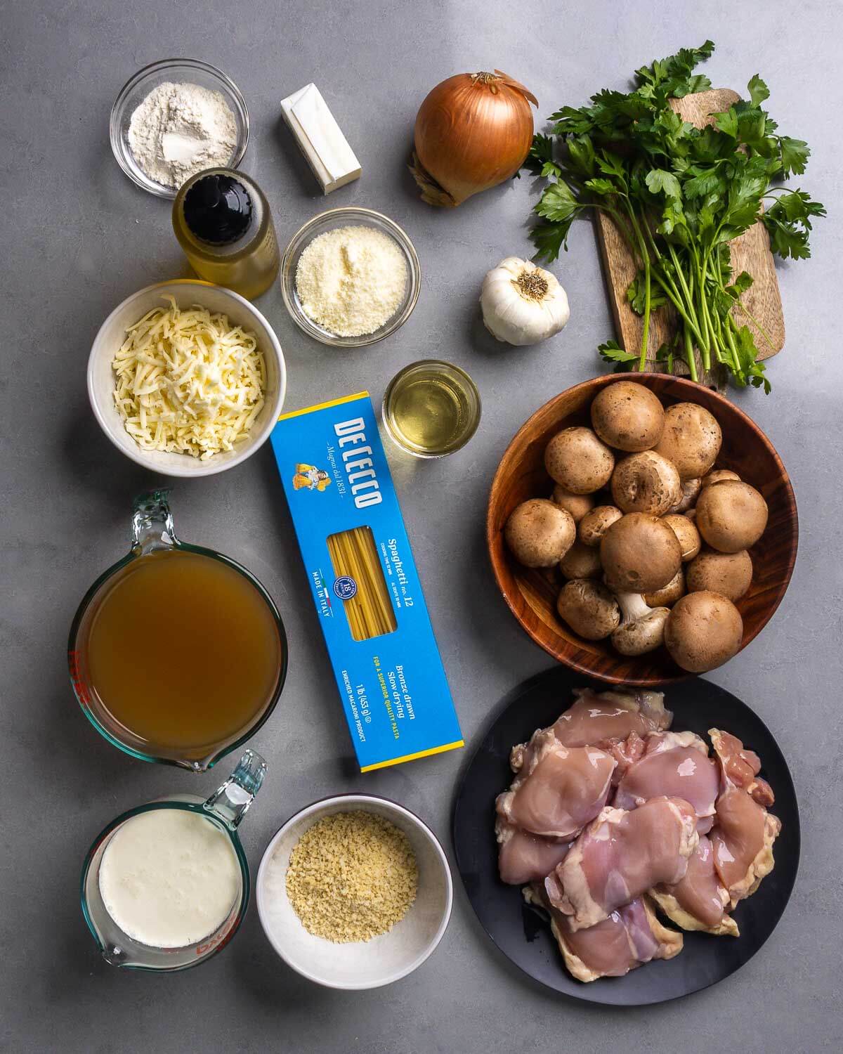 Ingredients shown: flour, olive oil, butter, parmesan, onion, garlic, parsley, mozzarella, wine, spaghetti, mushrooms, chicken stock, heavy cream, panko, and chicken thighs.