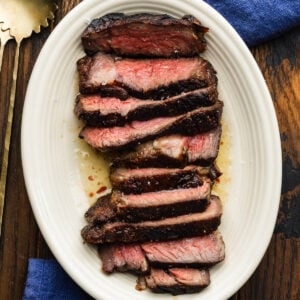 Reverse seared sliced ribeye steak in butter.