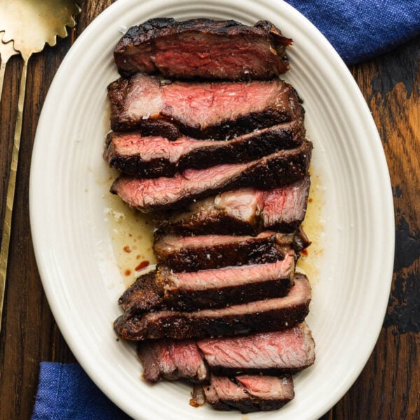 Reverse seared sliced ribeye steak in butter.